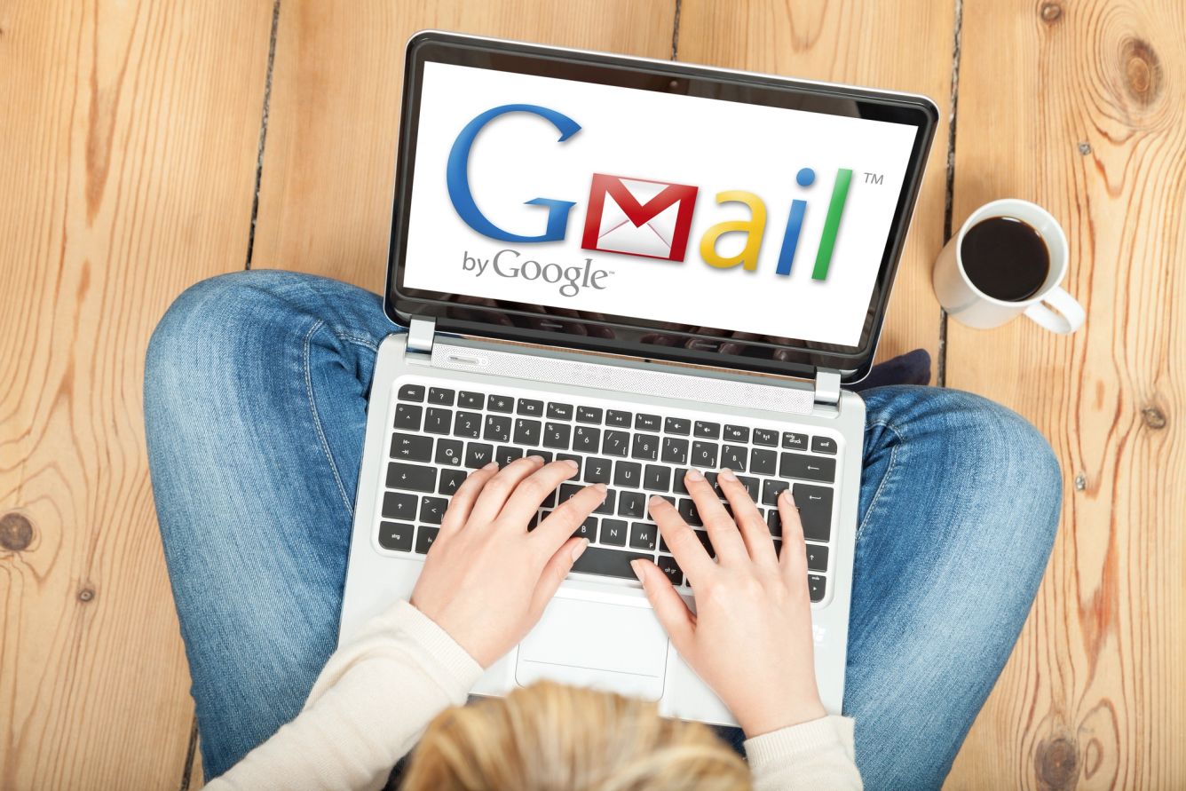 Laptop screen displaying the original Gmail logo.