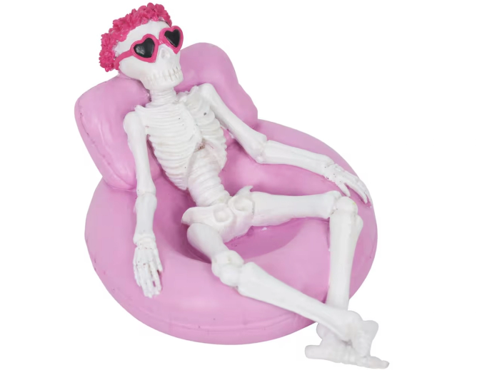 A Summerween figurine from Michaels of a skeleton relaxing in a pool float. 