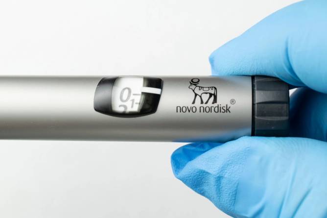 A hand holding a Novo Nordisk weight-loss injection