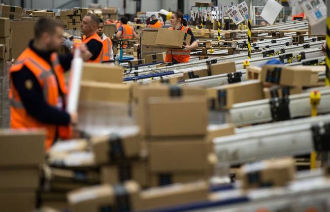 Amazon workers in a fulfillment center