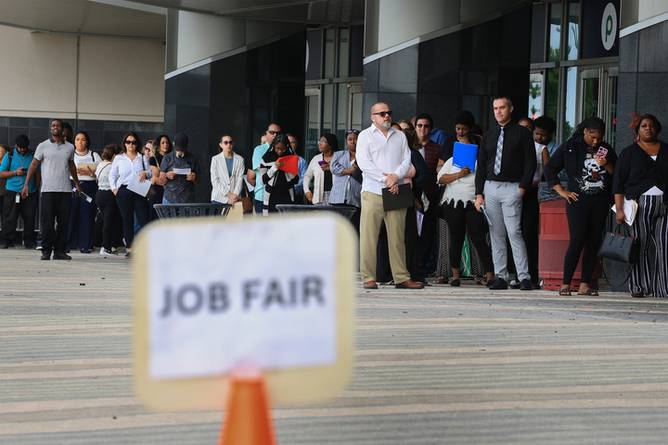 People standing at a job fair.