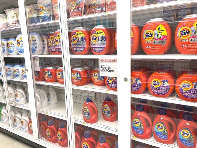 Laundry detergent in a locked display case in a Target. 