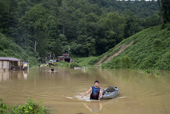 A man wades through flooding in Kentucky