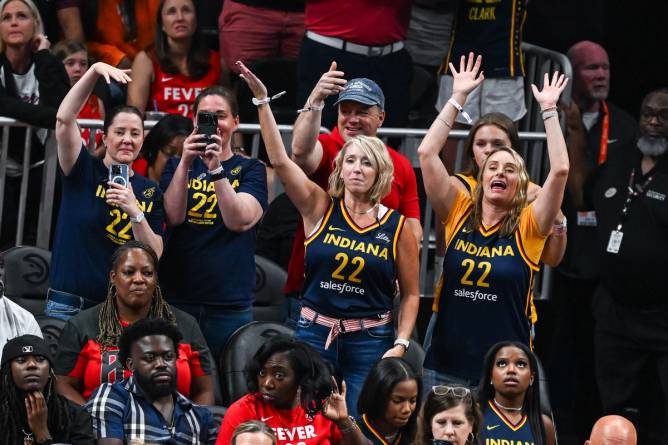 Women fans in Indiana Fever jerseys attending a WNBA game