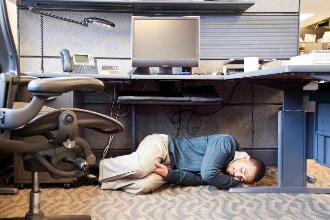 Man sleeping in cubicle