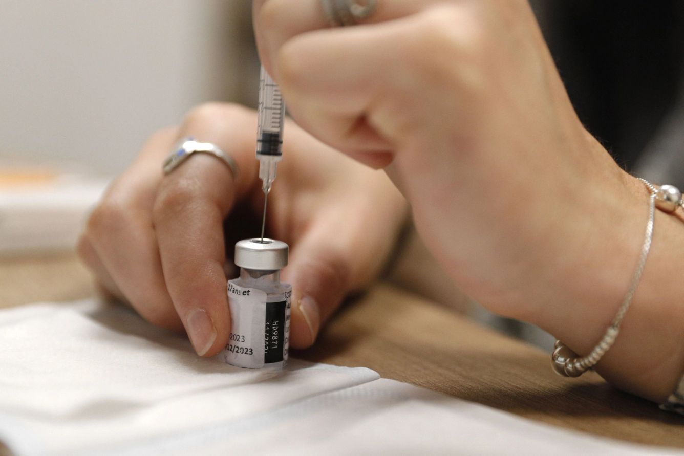 Vial of Covid-19 vaccine with a needle being stuck into it