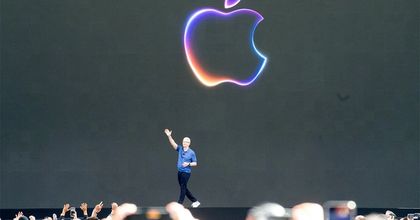 Tim Cook waving to a crowd on stage at WWDC 2024