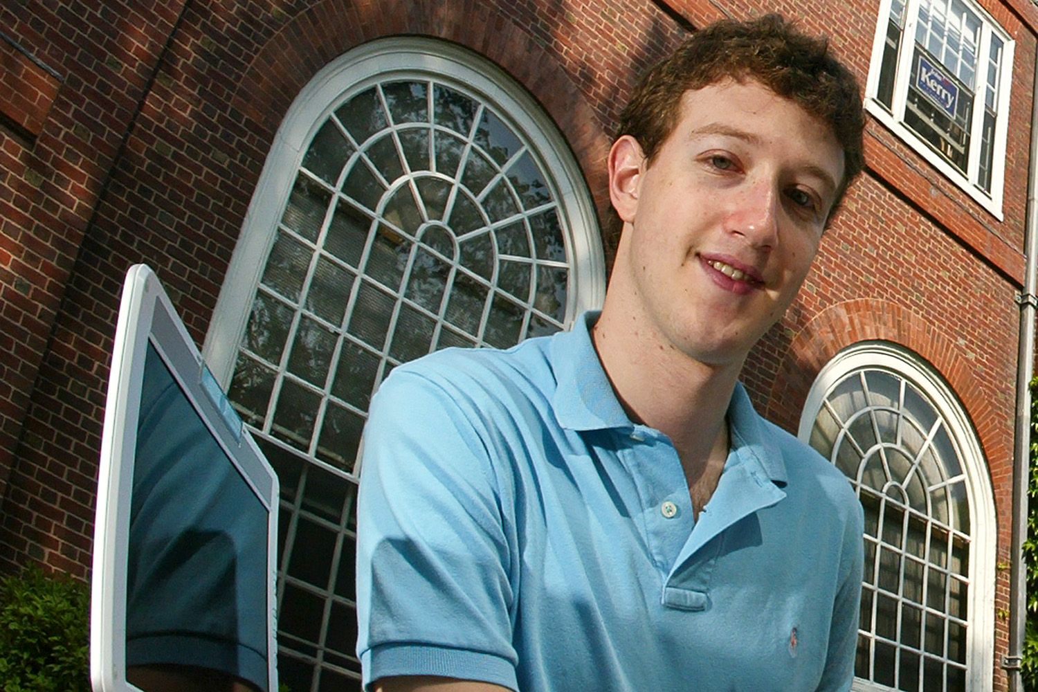 A portrait of young Mark Zuckerberg wearing a teal colored polo.