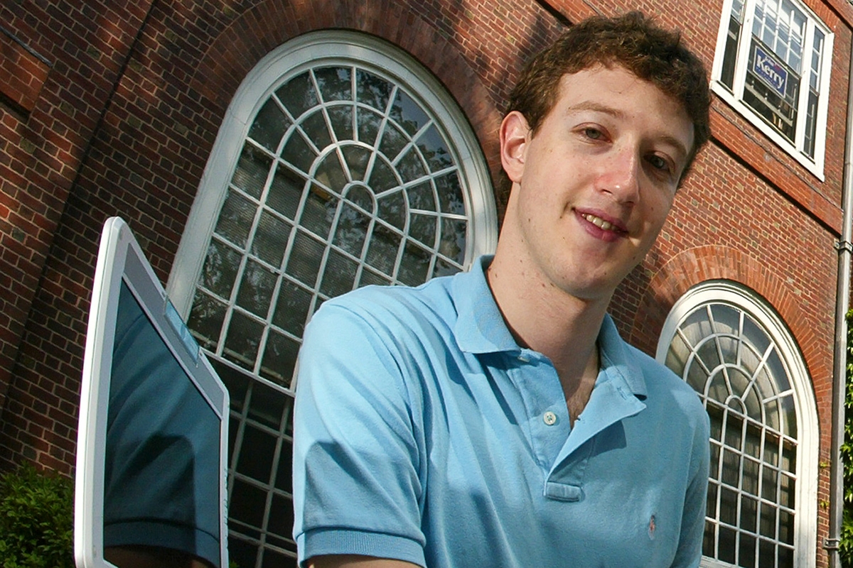 A portrait of young Mark Zuckerberg wearing a teal colored polo.