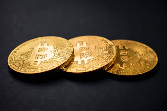 an image of gold tokens with bitcoin symbol on them