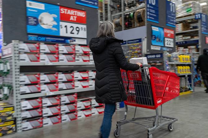 A shopper pushes a cart at a store