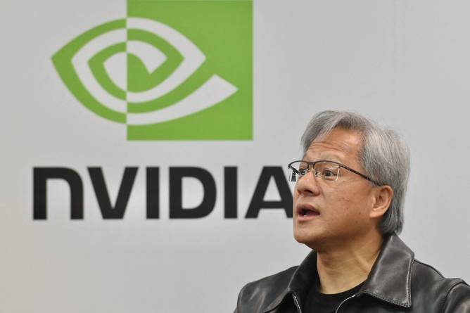 Nvidia CEO Jensen Huang in front of the Nvidia logo