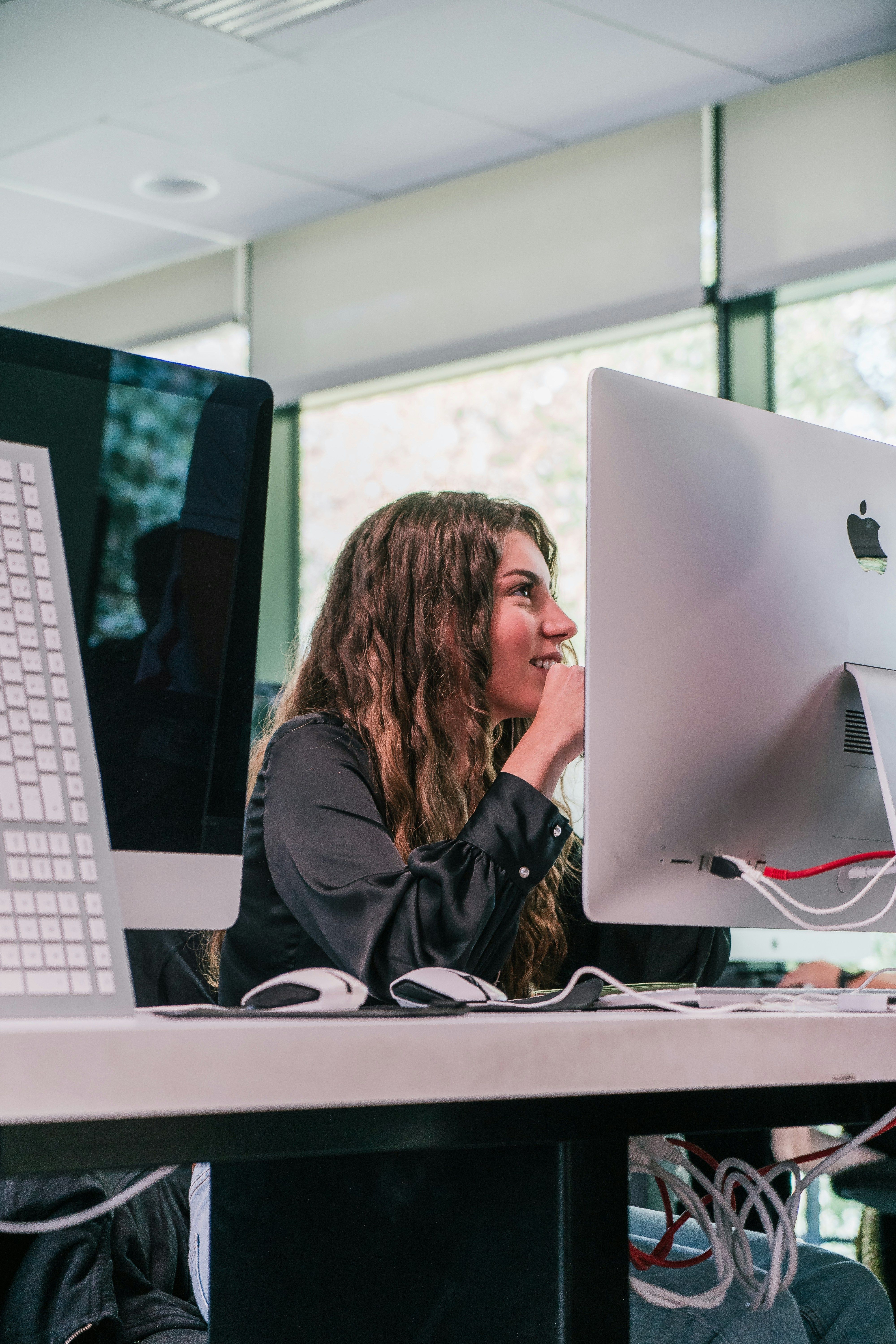 Woman working on computer in office.