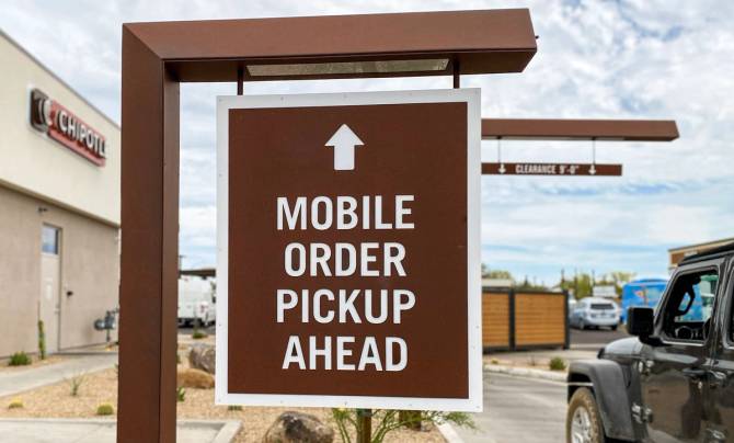 A sign for the Chipotlane window that says "Mobile order pickup ahead."