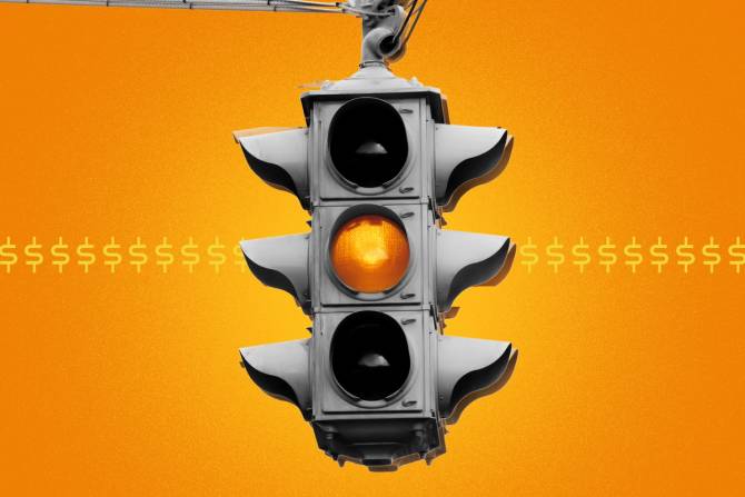 A yellow traffic light against an orange background