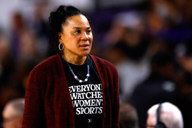 Dawn Staley wearing "everyone watches women's sports" shirt at South Carolina v. East Carolina basketball game