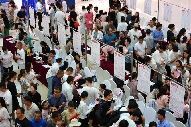 Crowd of young people in China at job fair.