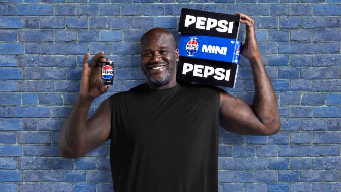 Shaq holding mini cans of Pepsi