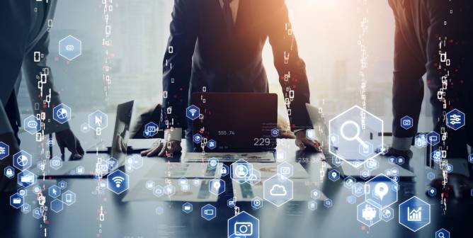 An employee stands at a desk, overlaid by images depicting digital transformation. 