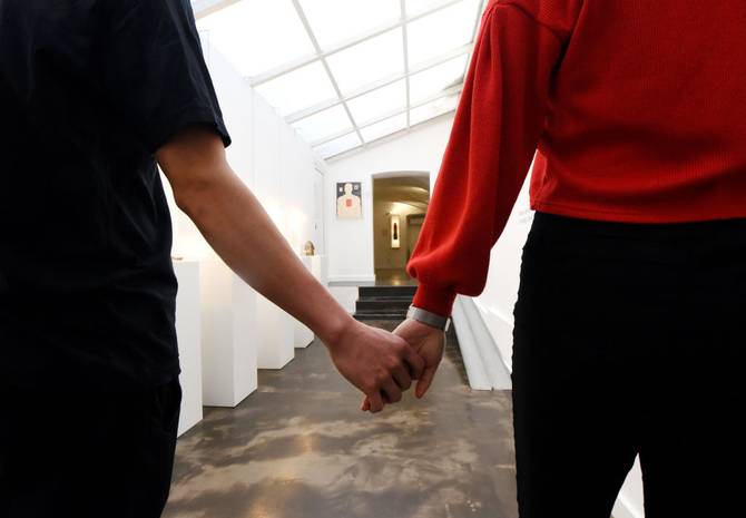 A couple holds their hands as they visit the Musem of Broken Relationships in Zagreb