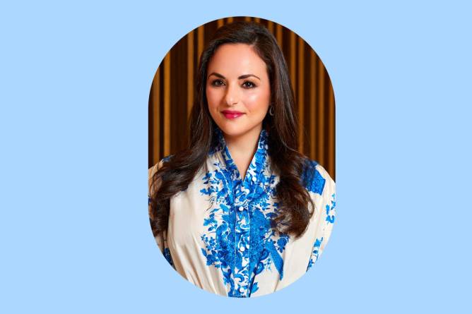 a photograph of Emily Essner in front of a light blue background 