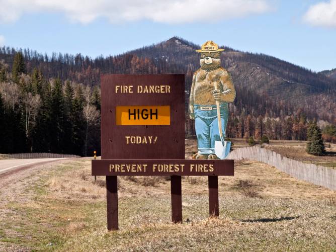 a Smokey Bear sign warning of high danger of fire