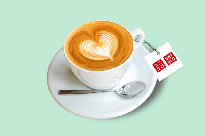 a capuccino in a white mug and saucer with a Uniqlo tag attached to the handle 