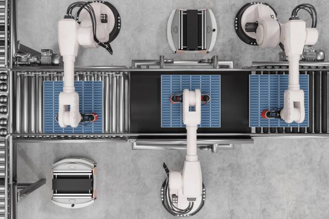 Robot arms assembling a solar panel.