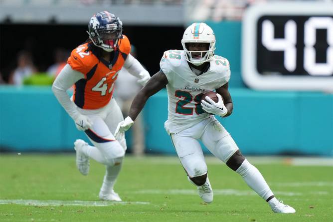 Miami Dolphins player runs during team's defeat of Denver Broncos