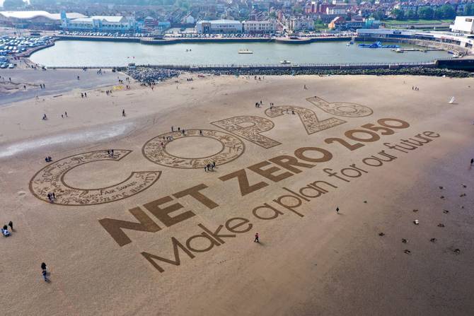 A giant sand artwork adorns New Brighton Beach to highlight global warming and the forthcoming Cop26 global climate conference