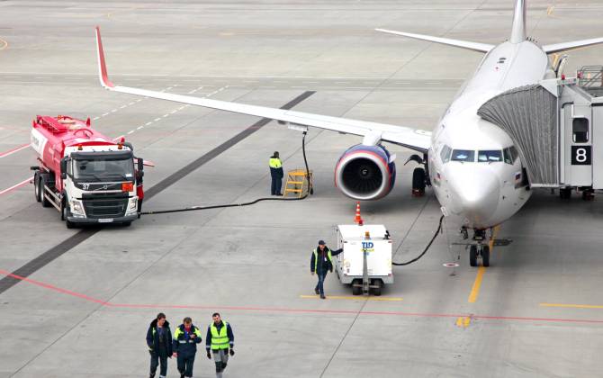 plane being refueled on runway