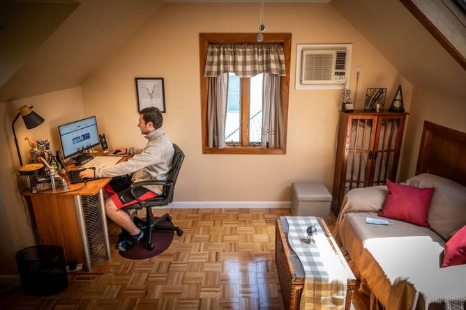 Man sitting in shorts works from home