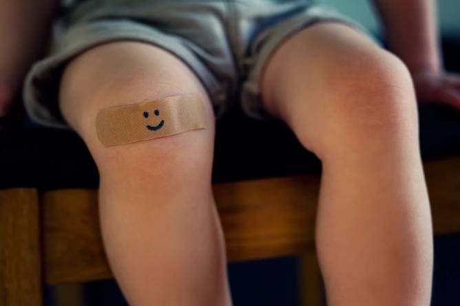 Child with band-aid on knee