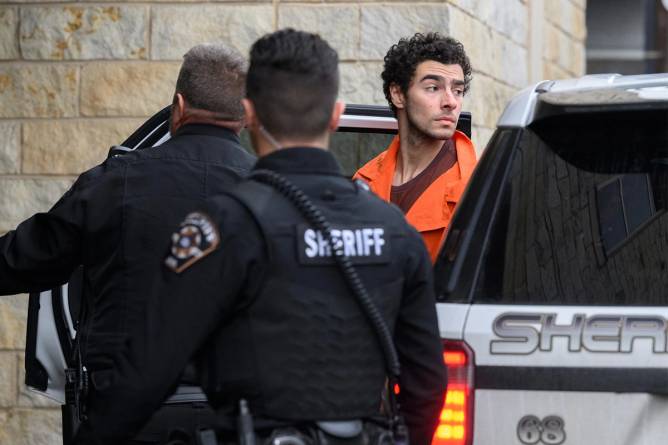 Suspected shooter Luigi Mangione is led into the Blair County Courthouse