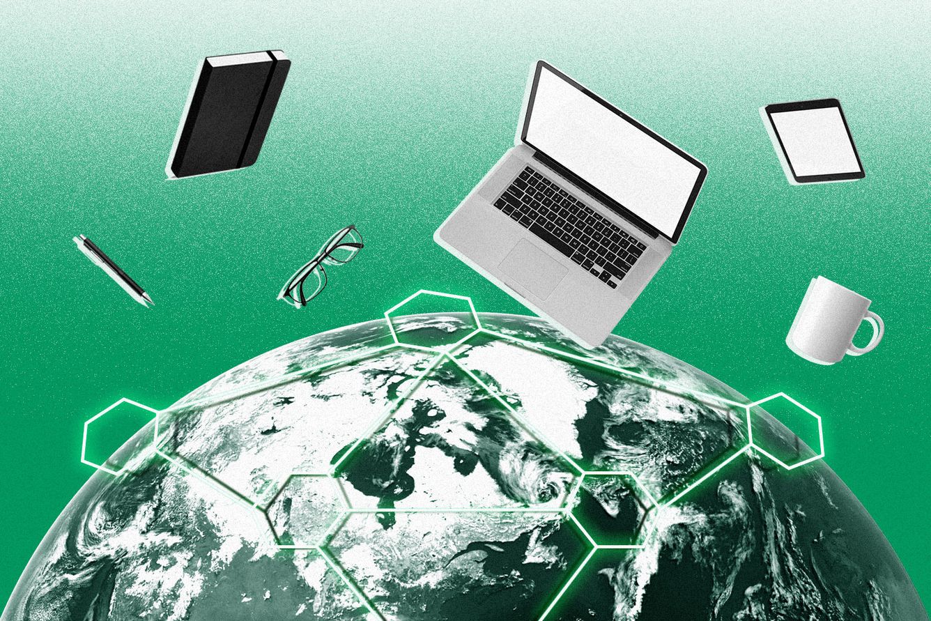 The top of a globe with a phone, notebook, laptop, glasses, iPad and coffee cup floating above it