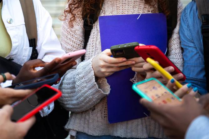 Teens on cellphones.