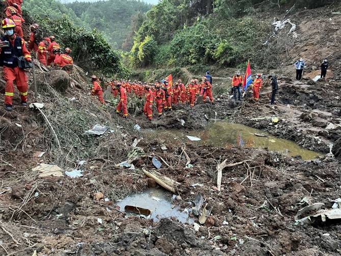Rescuers search for flight 5735's black boxes at the crash site.