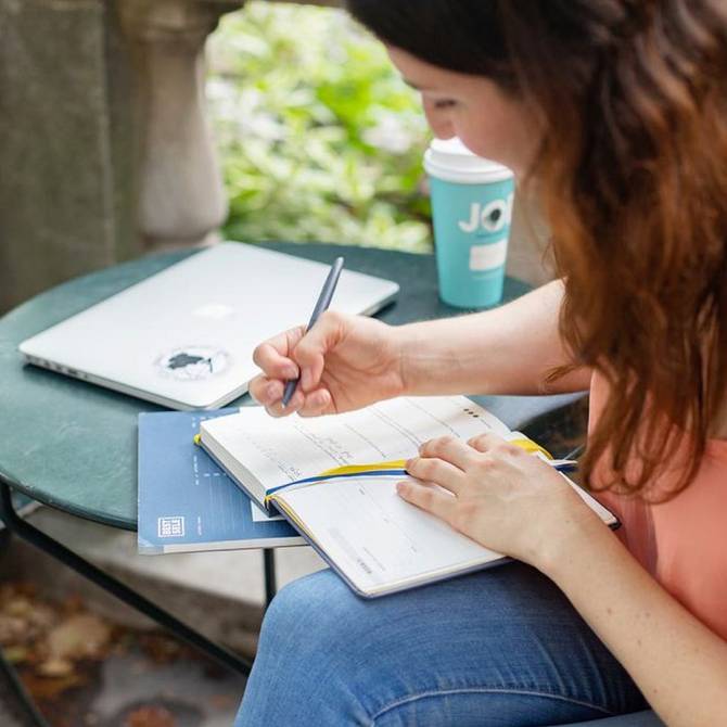 woman writing in her Self Journal