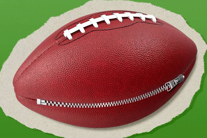 a football with a zipper running across it on a green background