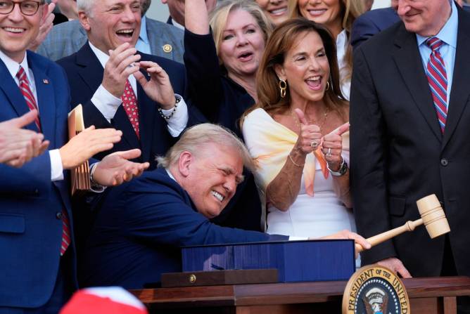 President Trump celebrates the signing of his massive tax-and-spending legislation