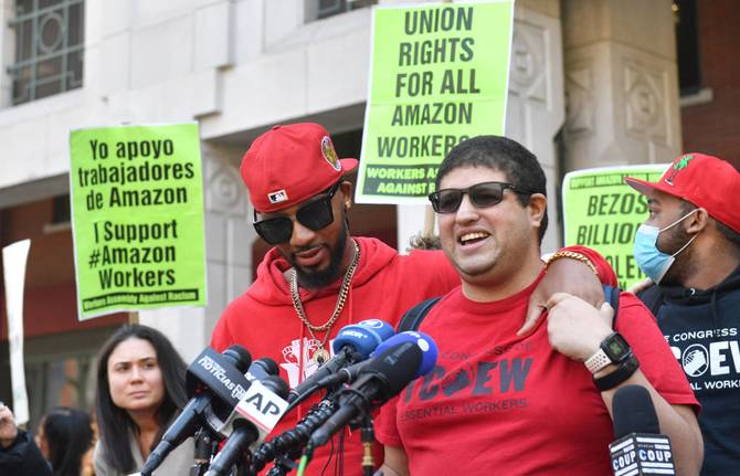 Workers celebrate after their Staten Island Amazon warehouse voted to unionize