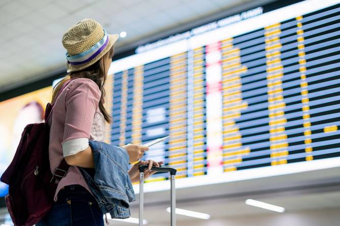 A woman checks her flight