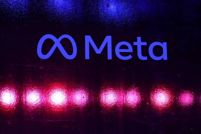 A Meta logo appears in front of a black background at a company event in Mumbai 