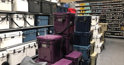 Inside a retail store displaying Yeti coolers in a range of different colors
