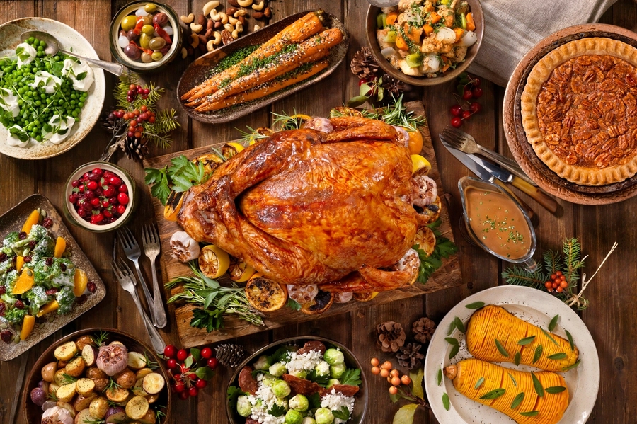 A photo of a table with a Thanksgiving turkey and sides