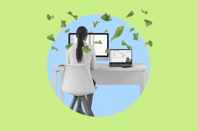 An office manager sitting at a desk in front of two computers with money floating around her