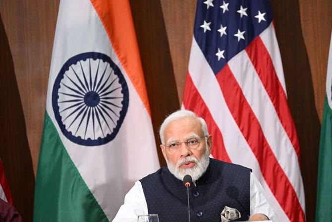 Indian Prime Minister Modi in front of Indian and US flags on his state visit to the US