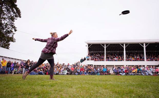 A woman throwing a cast iron skillet as part of a competition at the Fryeburg Fair in Maine