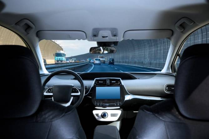 Front seat of a self-driving car as viewed from the backseat. 