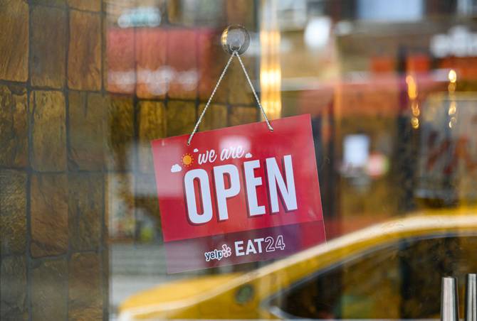 A 'We Are Open' sign is seen outside a restaurant in Kips Bay during the coronavirus pandemic